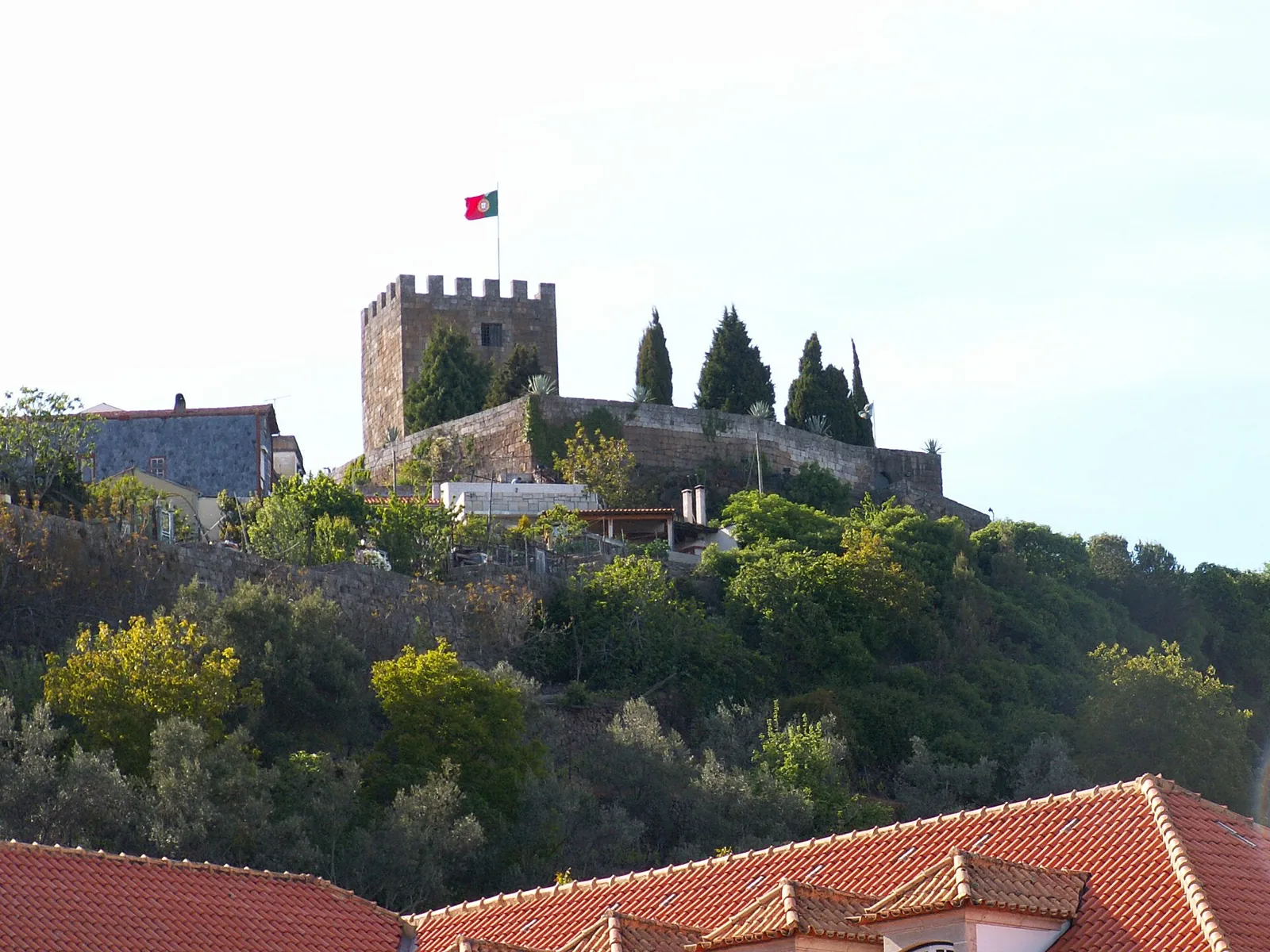 Lamego Castle on the hilltop, with a flag flying on the tower