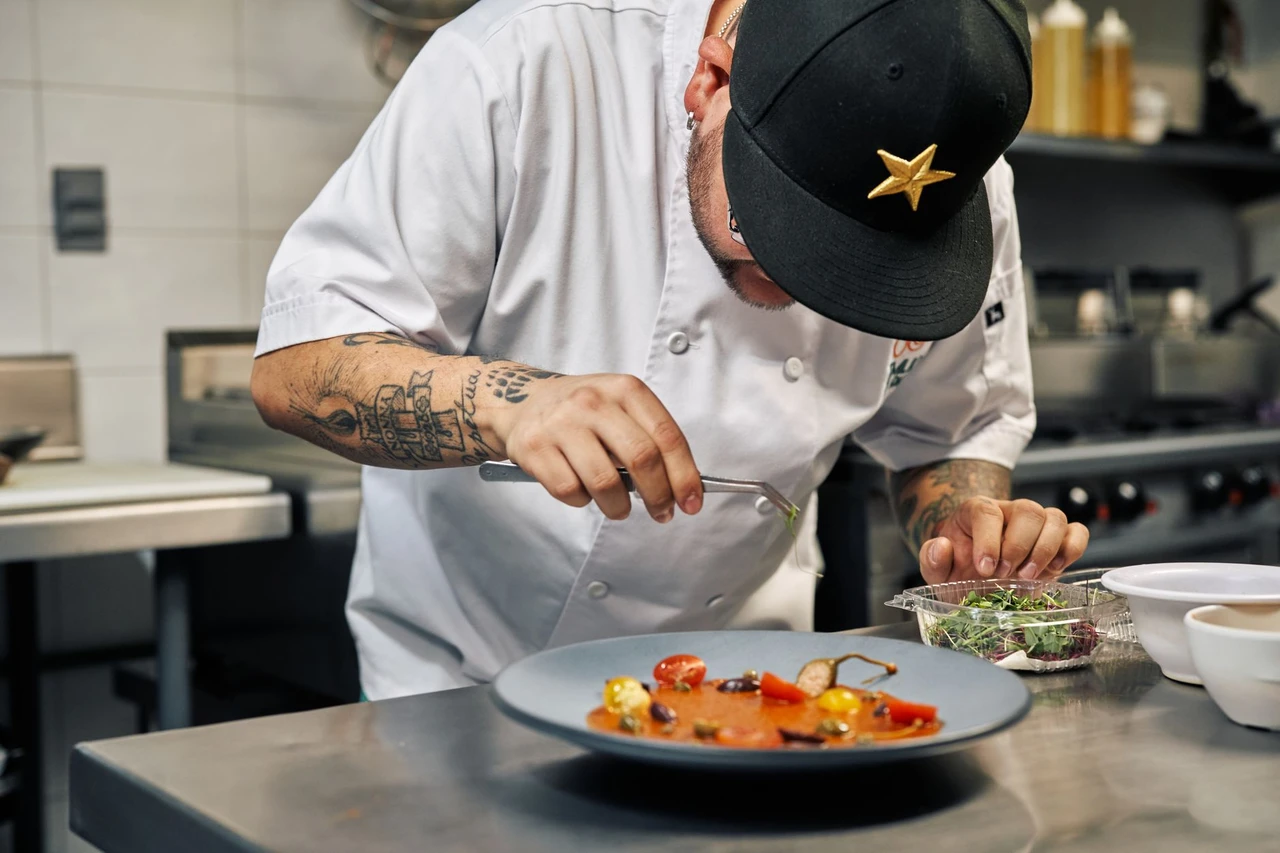 Chef plating a gourmet dish in a professional kitchen, reflecting the technique behind the Douro Valley's fine-dining scene